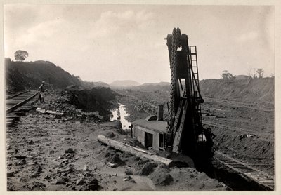 View of laborers digging the Panama Canal with railroad tracks and digging machine, 1912 or 1913 by Byron Company